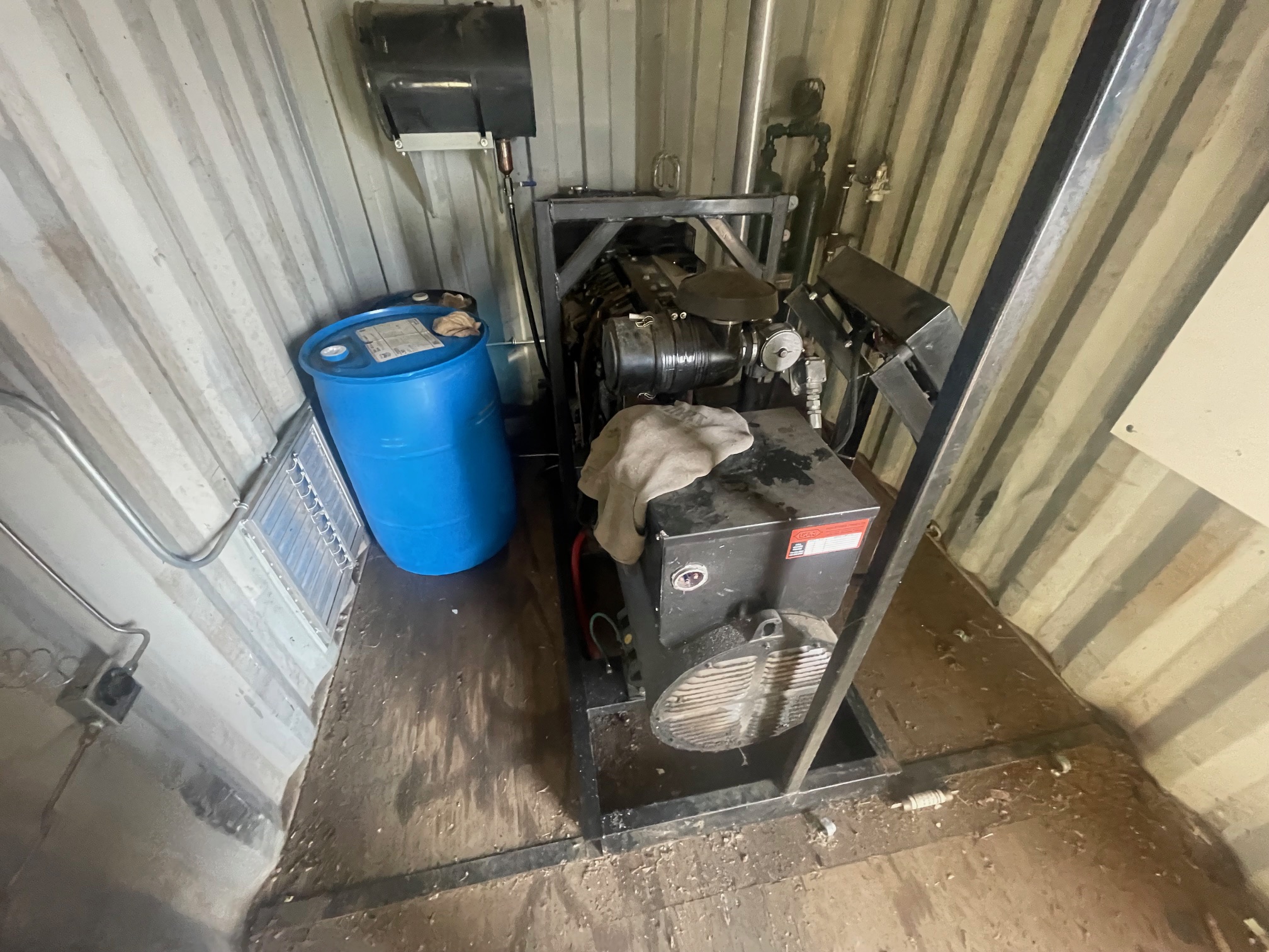 skidded genset housed in 20' seacan with air compressor and work space.